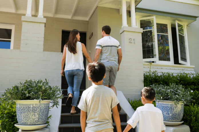 Family entering new home purchased with house deposit